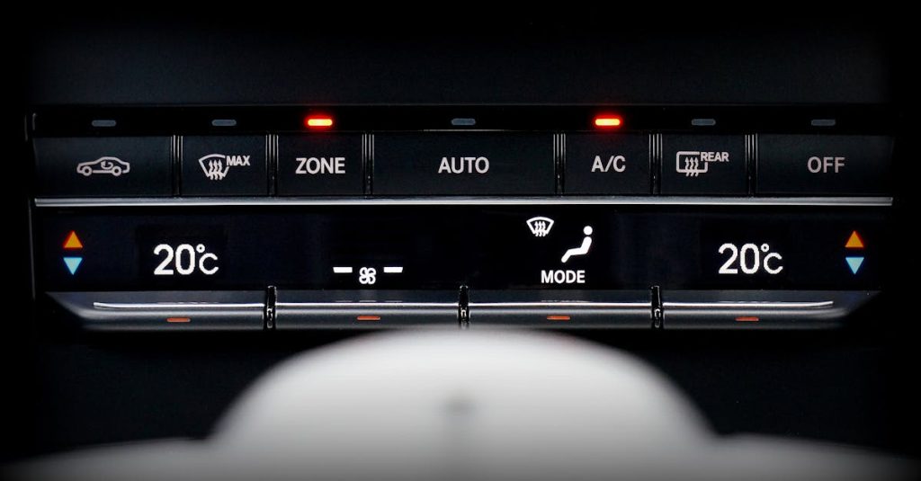 Close-up image of a car's climate control panel with digital temperature display.